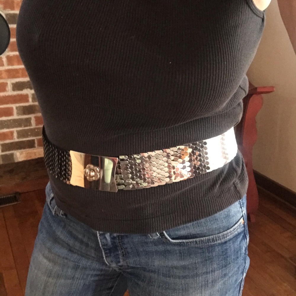Silver metal belt with flower buckle.